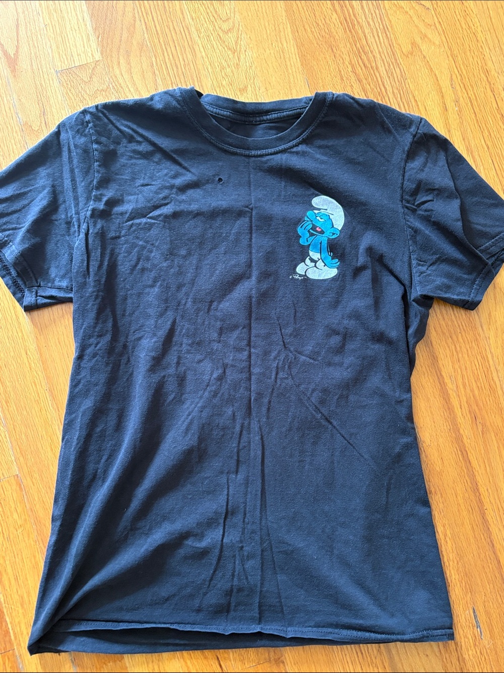 Black T-Shirt with Small Blue Smurf hanging under mushroom  Graphic